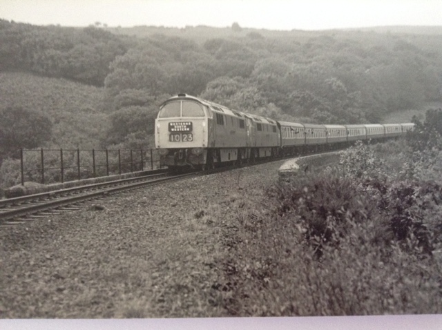 The return train clearly seen on Fatherford Viaduct note the absence of the Okehampton Bypass A30 dual carriageway.brPhotographer Grenville R. HounsellbrDate taken 30101976