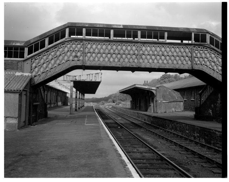 Okehampton station in 1986 showing the unrebuilt Platform 2 buildings, sidings where the cycle hire business now operates, and window frames in the footbridge.brPhotographer Mr Bowden