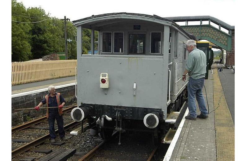 Coxon and Kelsey grapple with the railway's motley collection of hosepipes, in an attempt to clean the LMS brakevan.brPhotographer Paul MartinbrDate taken 18062013