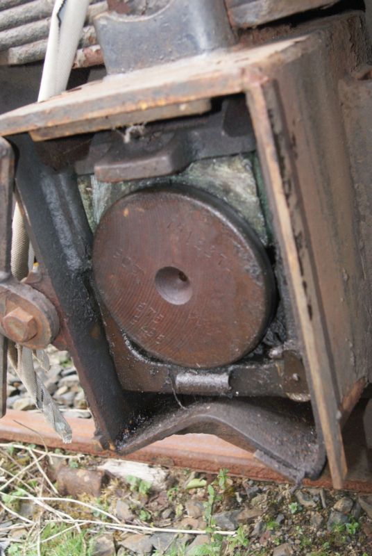 Axlebox showing bearing and retaining plate above the axle, and oiler below. Unfortunately the bottom face of the axle box is bent where it has been jacked without anything to spread the load, thus slightly crushing the oiler and restricting the vertical movement of the box necessary to remove the bearing. The other box on this axle is in the same condition.brPhotographer Jon KelseybrDate taken 16042016