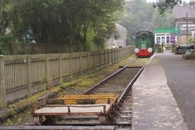 View from the platform end, with a couple of permanent way trolleys in the foreground, and the John Fowler diesel shunter 'Progress' and Mk1 coach by the old station building, which is now the Puffing Billy restaurant.brPhotographer Jon KelseybrDate taken 10092017