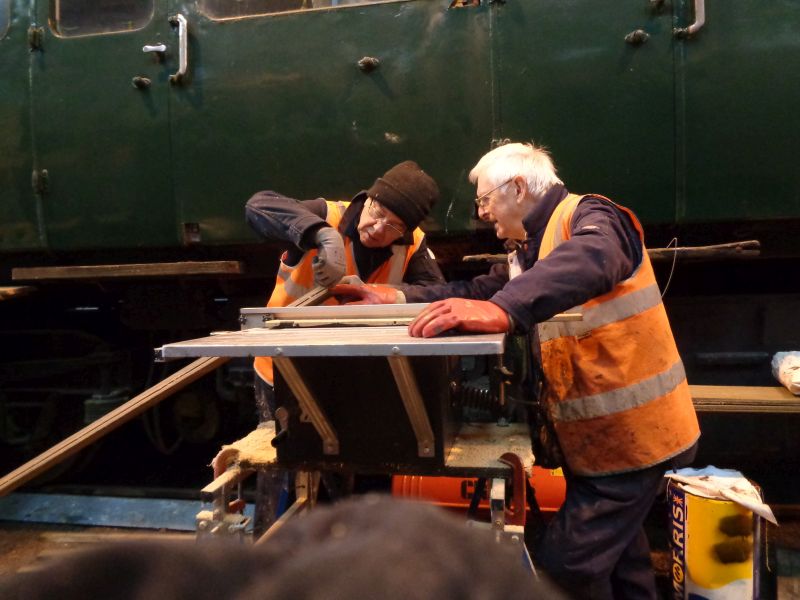 John Coxon and Ron Kirby setting up the flat-bed saw ready to rebate planks for the SR brake van sidesbrPhotographer David BellbrDate taken 08022018