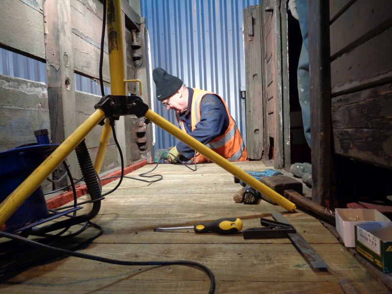 Veranda flooring on the SR brake van at one end almost completed. Patrick Doyle cutting off protruding bolt heads.brPhotographer David BellbrDate taken 08022018