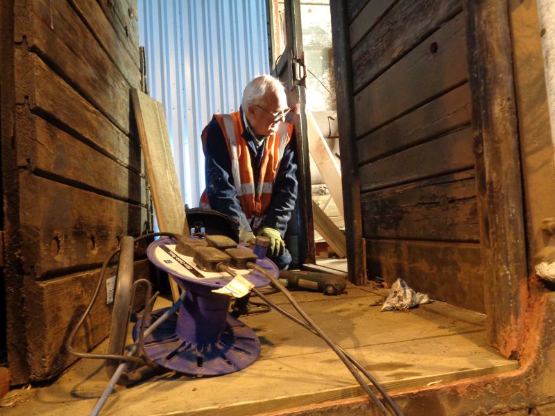 Patrick Doyle watching John Davis removing the hinge pins on the brake-van doorbrPhotographer David BellbrDate taken 01112018