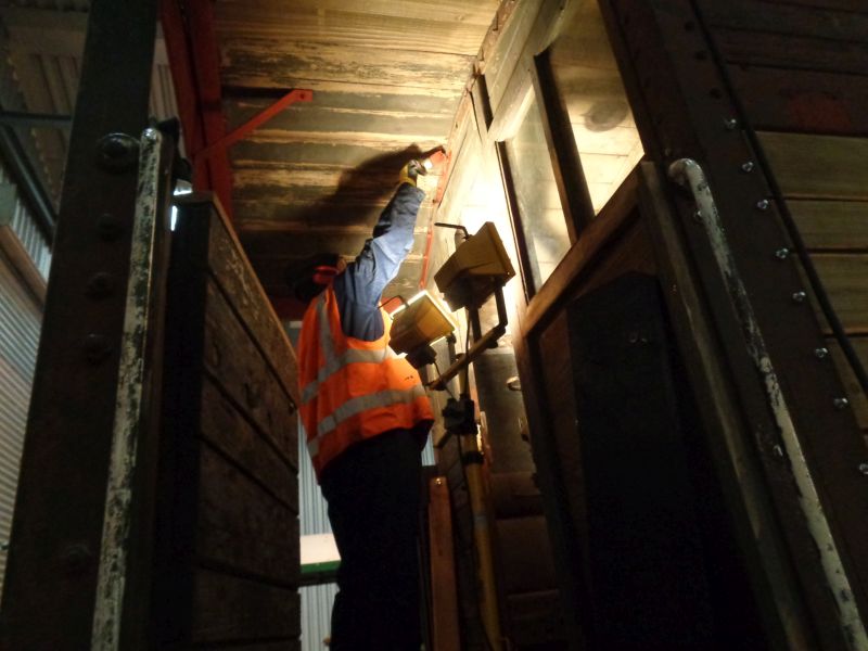 Patrick Doyle basks in the warm glare of floodlights while applying red oxide primer.brPhotographer David BellbrDate taken 10012019