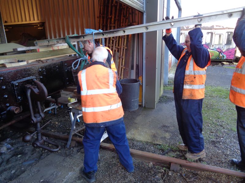 Geoff Horner gives Ron Kirby a welcome hand on lifting whilst John Coxon and Terry Bridgeman fit the buffer on.brPhotographer David BellbrDate taken 17012019