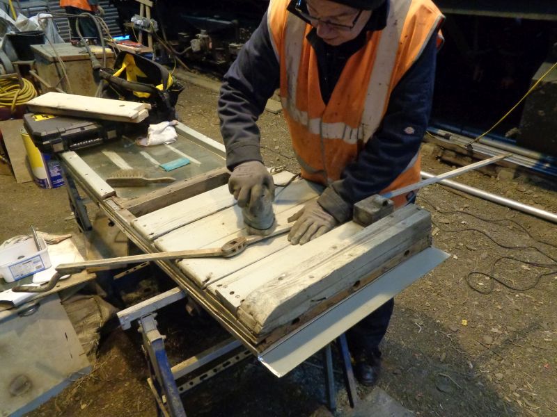 Ron cleaning up the door locking bar, regretting that he forgot to photograph the door before dismantling various partsbrPhotographer David BellbrDate taken 28022019