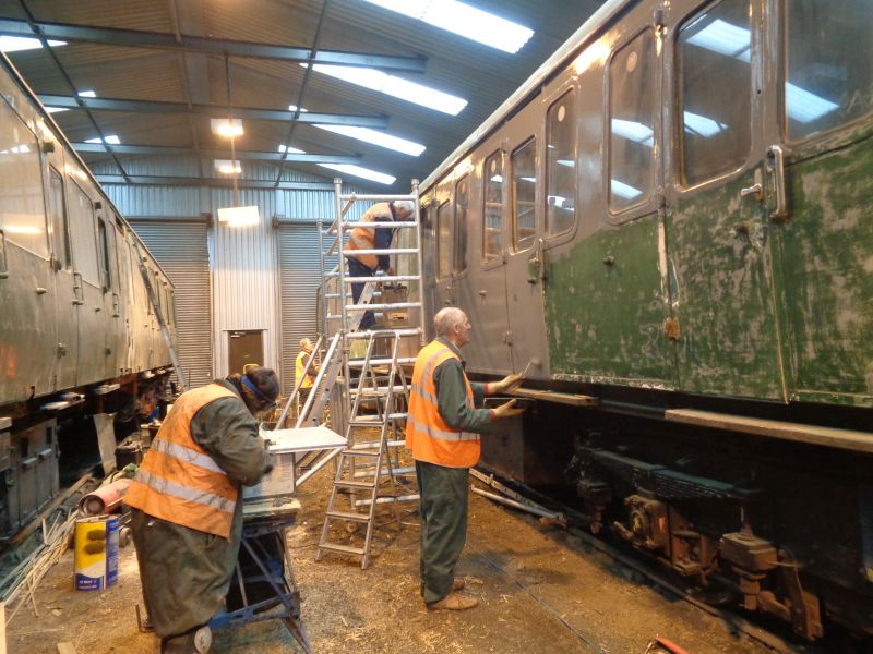 Nigel Green, John Coxon on stage and Terry Bridgeman in the background apply undercoatprimer to the Thumper 1132 power car.brPhotographer David BellbrDate taken 14032019