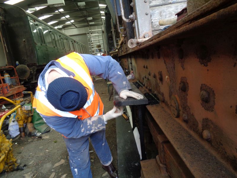 On the SR brakevan LDS 55625, Phil Hull mounts the new running boards he has fabricated onto the freshly painted brackets. Note the circular plate on the frame which states that the van had an Interim Repair in 1973. Only 2 coats of paint appear to have been applied overall since it was built in 1948.brPhotographer David BellbrDate taken 18042019