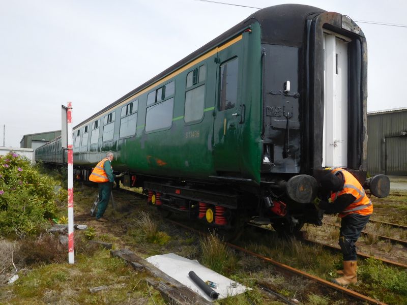 Nigel Green applying the last of the top coat needed to repair the graffiti damage of late last year whilst Terry Bridgeman replaces the vacuum brake pipe to the west end having previously done the same at the east end. Once the main vacuum cylinder has had its overhaul the FK will be ready to return to service.brPhotographer Geoff HornerbrDate taken 16052019