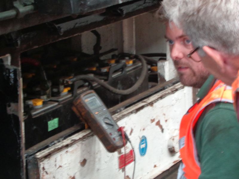 Julian checks that charging current is flowing whilst Terry Bridgeman takes an interest. There be 90 volts and an awesome lot of amps in therebrPhotographer David BellbrDate taken 23052019