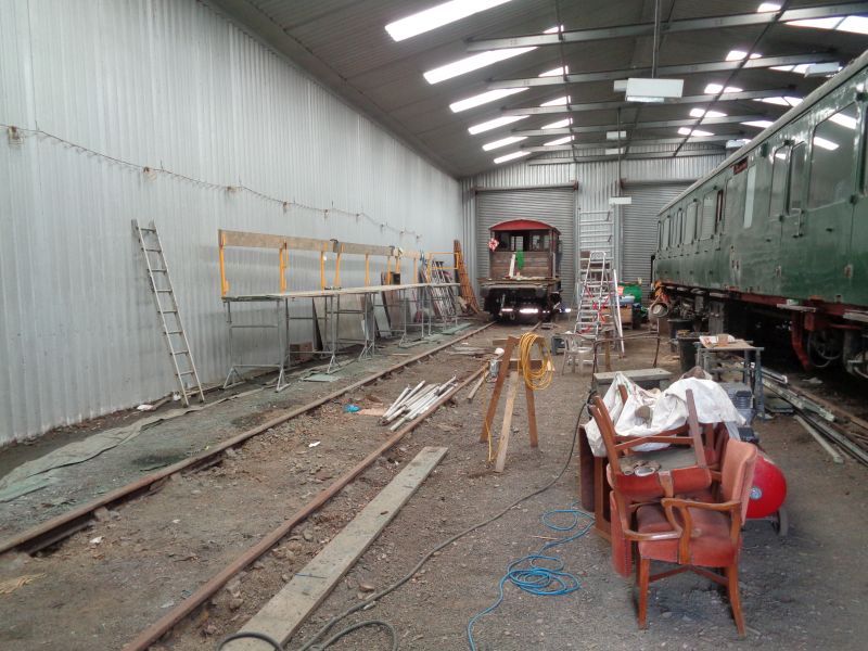 A rarely seen view the vacant space on the North side of the workshop, left by the outshopped Thumper 1132 motor  section, with just the SR brake van LDS55625 at the far end. Working conditions on the North side of rolling stock parked here are rather cramped and require additional lighting most of the time.brPhotographer David BellbrDate taken 06062019
