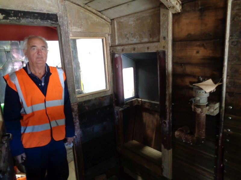 Patrick Doyle pauses from work inside the SR brake van. One of the new ducket seats can be seen. The glazing on the two duckets has been fitted and most of the internal woodwork has been prepared for painting and awaits fitting the internal wall plywood lining.brPhotographer David BellbrDate taken 04072019
