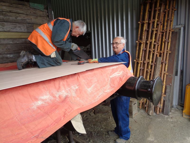 John Davis and Patrick Doyle cutting out plywood sections to line the SR brake van cabin.brPhotographer David BellbrDate taken 11072019
