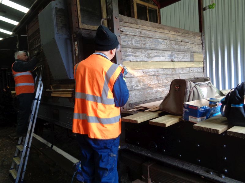 Patrick moves elsewhere with the grinder whilst John gets on with filling-in. The nearby bag wasn't at risk and survived intactbrPhotographer David BellbrDate taken 10102019