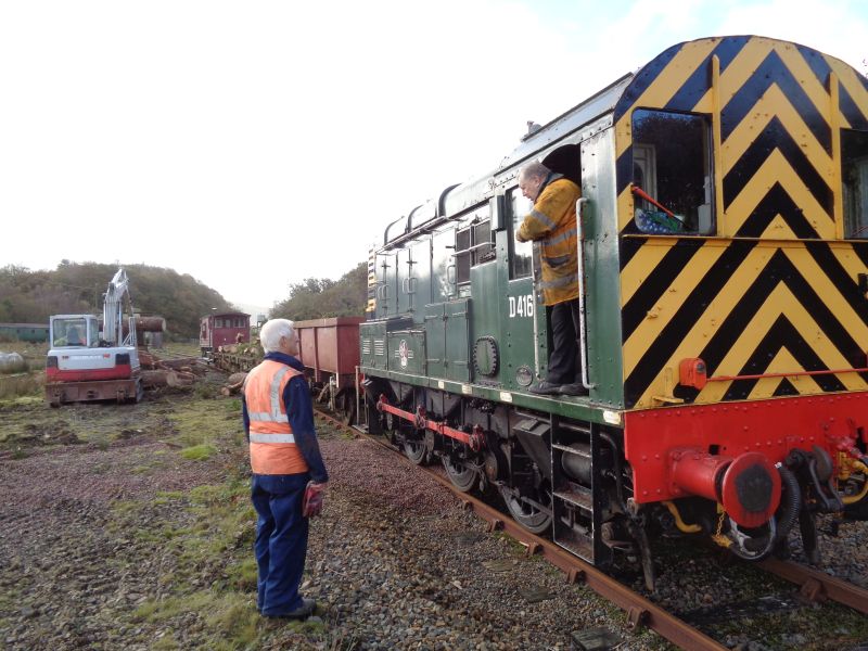 John Coxon chats with Graham Isom whilst Brian Mills DRCIC unloads cut timber from the DR Sturgeon flatbed wagon. Note the DRSA brake van proudly carrying out the sort of duty it was built for.brPhotographer David BellbrDate taken 24102019