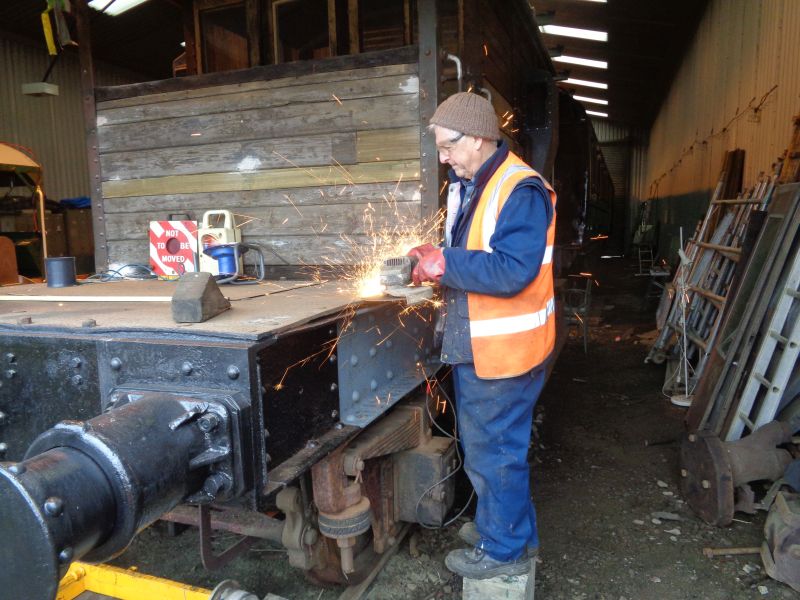 Countersunk bolt heads being ground away by John. Note the buckled plate.brPhotographer David BellbrDate taken 05032020