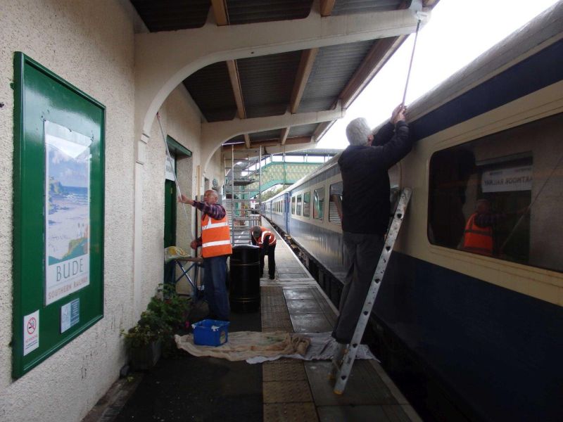 At last a use for one of those coaches. The Station Maintenance team at work painting the platform 2 building wall and awning supports.brPhotographer Tom BaxterbrDate taken 14102020