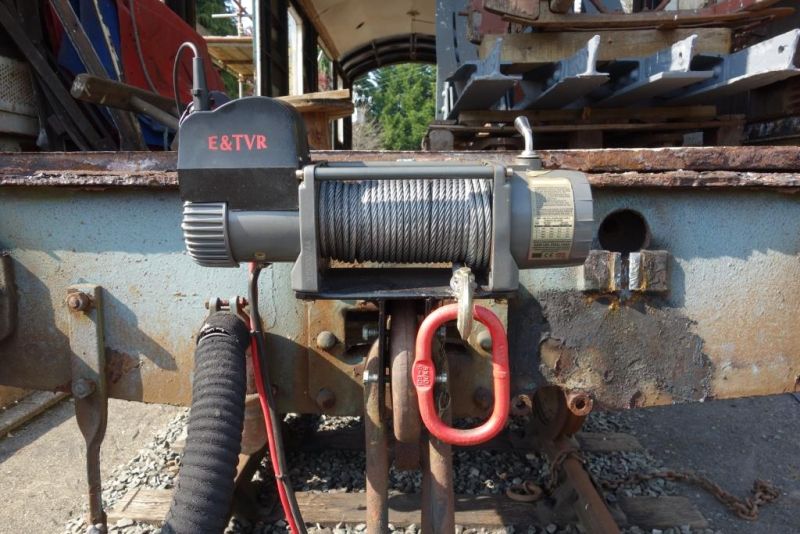 Being without a loco, I am reduced to shunting with this 24V winch, mounted on a frame which sits in four draw hook patterns the set screws take up the different widths. 