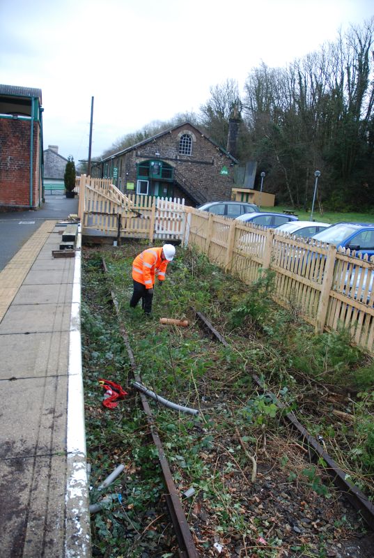 Work begins on clearing the vacated bay siding. A DRSA volunteer approaching a hazardous part of the DRCIC sleeper plumbing.brPhotographer Paul VoddenbrDate taken 23032021