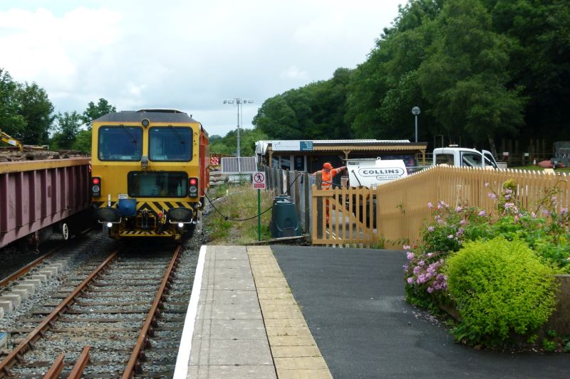 The tamper standing on the down platform siding extension, being refuelled from a road vehicle positioned in the Youth Hostel yard.brPhotographer Dave EllisbrDate taken 07072021