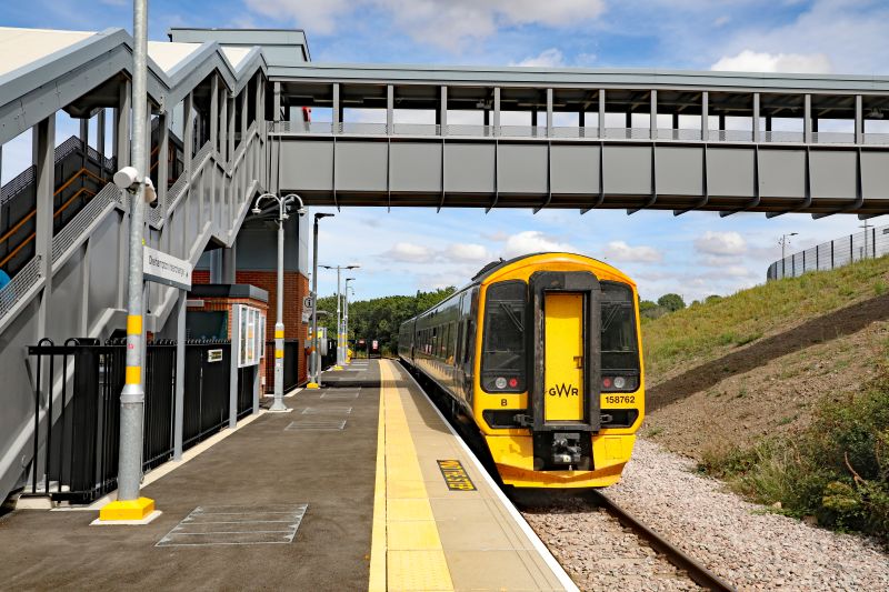 The modern bland functional station with the dominating footbridge. 158 762 stands out well going away from the camera with 2R58 1423 Okehampton-Exeter St DbrPhotographer Bernard MillsbrDate taken 01082026