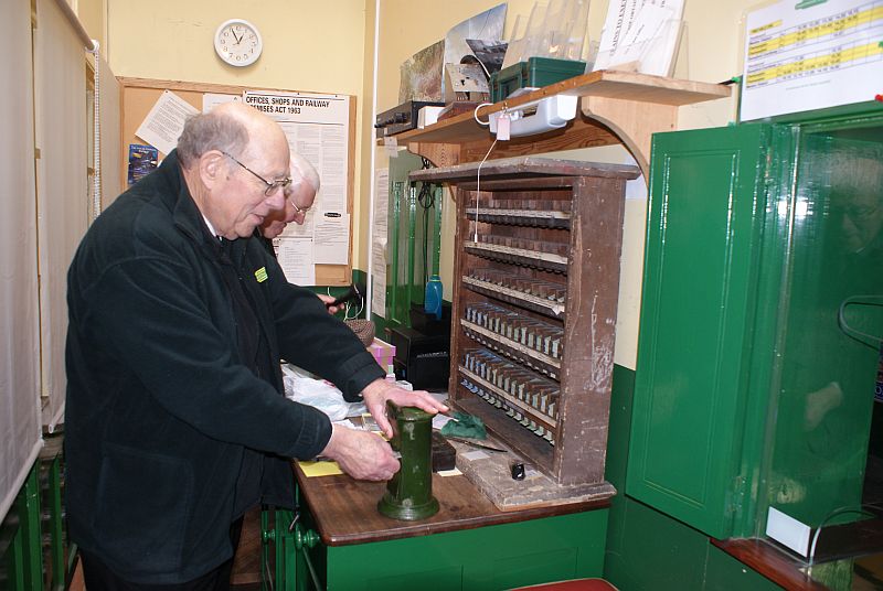 Peter Ritchie and Graham Parkinson hard at work in the Okehampton ticket office