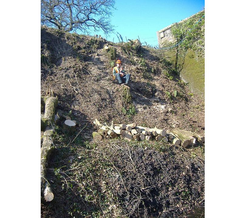 John Wills impersonates a pixie sitting on one of Andy Webb's steps by Lydcott Bridge.brPhotographer Sue BaxterbrDate taken 05032013