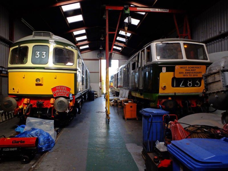 Scene inside the shed at Williton, headquarters of the Diesel and Electric Preservation Group. Class 33 D6566 l and Class 35 Hymek D7018 r. Hymek D7017 can just be seen outside the shed gate.brPhotographer Philip Wagstaff