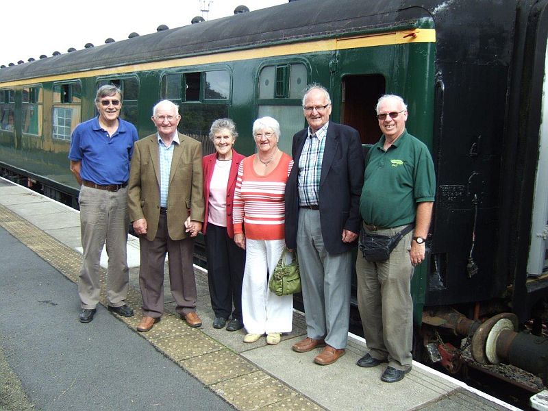 Dick Henrywood and Geoff Horner with Mr and Mrs Ken Heard and Mr and Mrs Derek Webber of Okehampton United Charities.  OUC provided financial help with the restoration of the FK, seen in the background.