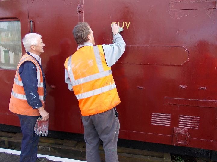 Paul Martin r and John Coxon figuring out how to stick the letters on.brPhotographer Jon KelseybrDate taken 03032012
