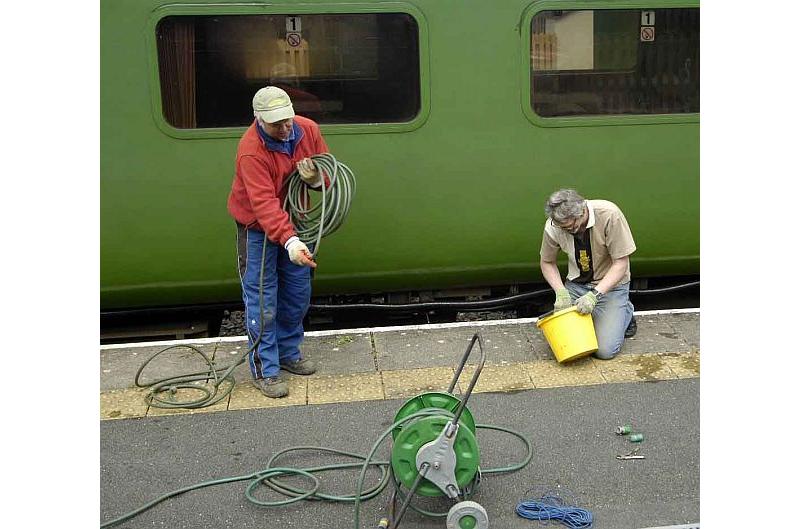 Tom Baxter trying to build a big hose from lots of little ones, while Mark Williams does something with a bucket. What does it all meanbrPhotographer Paul MartinbrDate taken 27042013