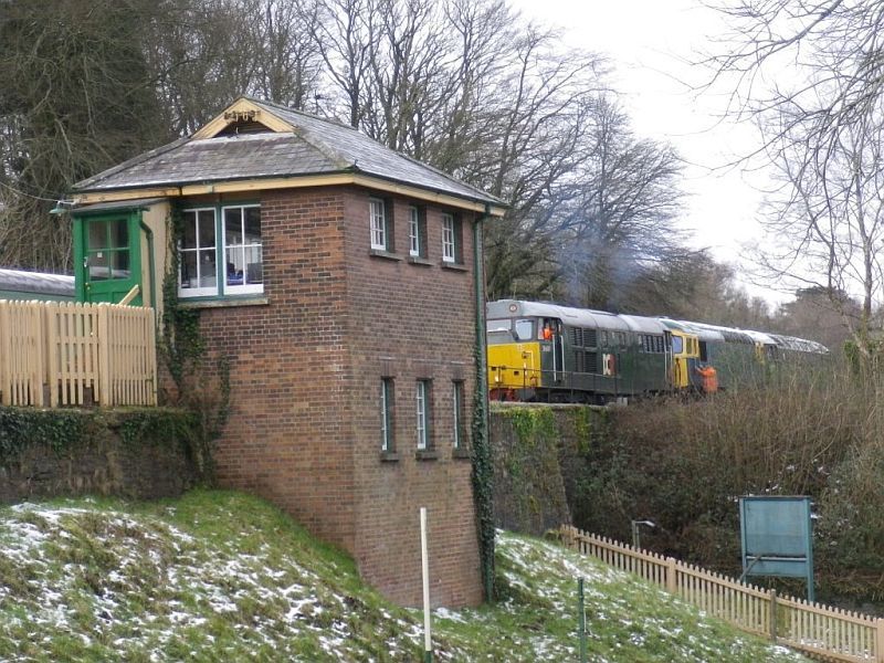 Viewed beyond Okehampton's distinctive signal box, 31601 prepares to remove Polar Express traction 33103 and 47701