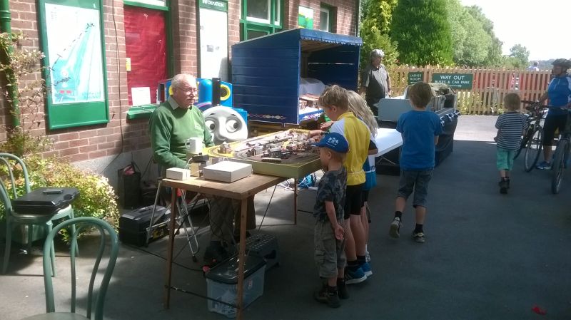 Former DRSA model railway volunteer Stan Agar explains things to enthusiastic youngsters